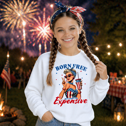 Girl wearing a 'Born Free But Now I'm Expensive' sweatshirt with fireworks in the background