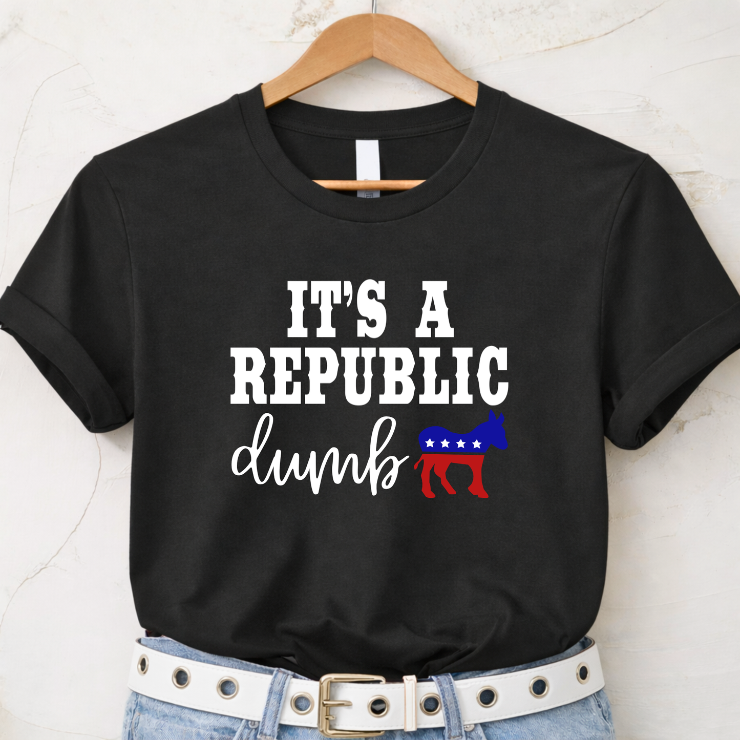 Black t-shirt with 'It's a Republic dumb' text on a hanger against a white background