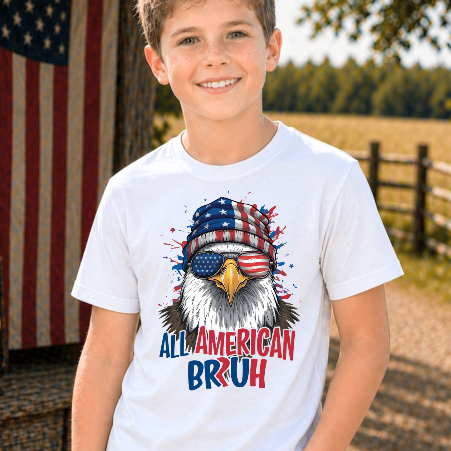 Child wearing a t-shirt with an eagle graphic and 'All American Bruh' text, standing outdoors.