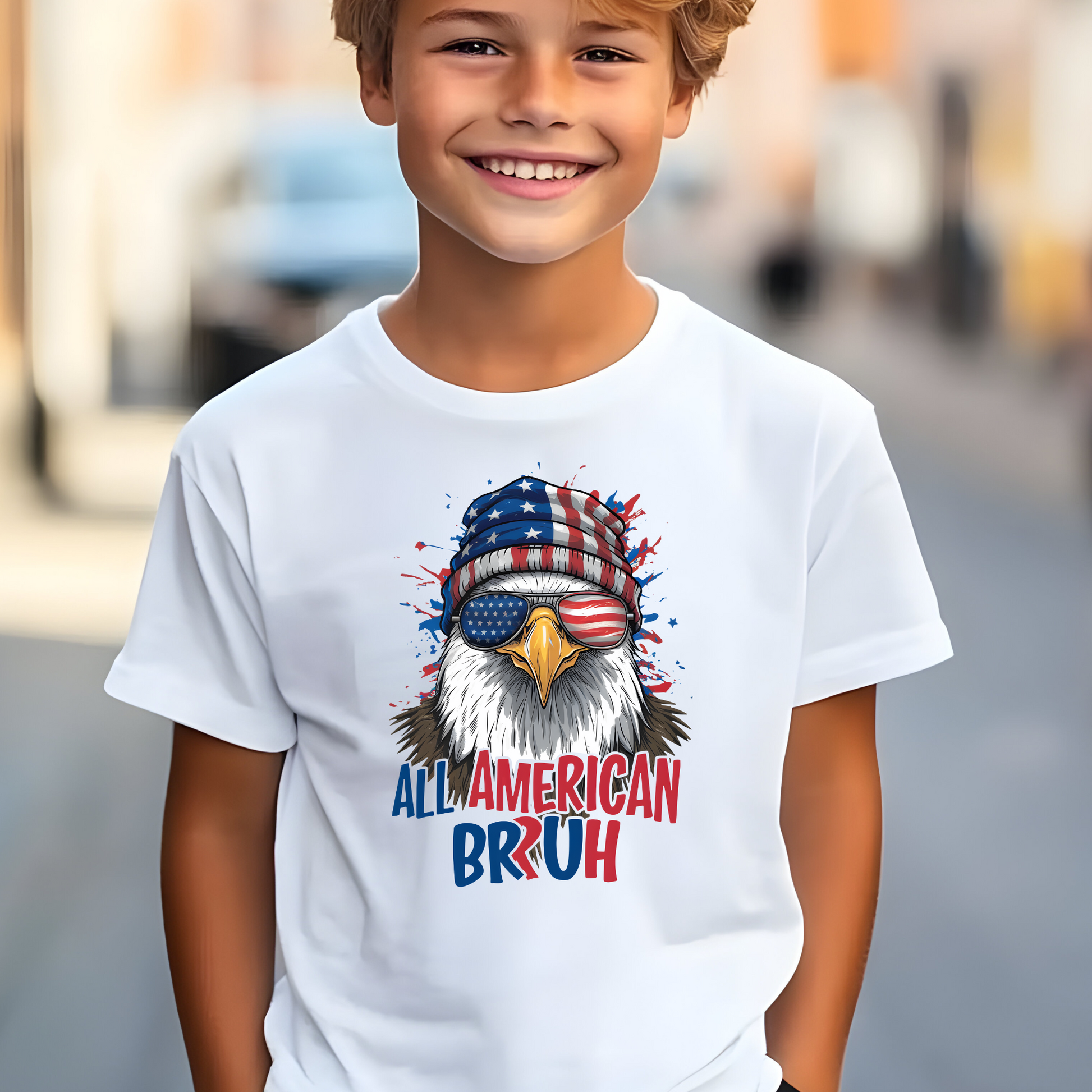 Child wearing a white t-shirt with an eagle graphic and text, standing outdoors.