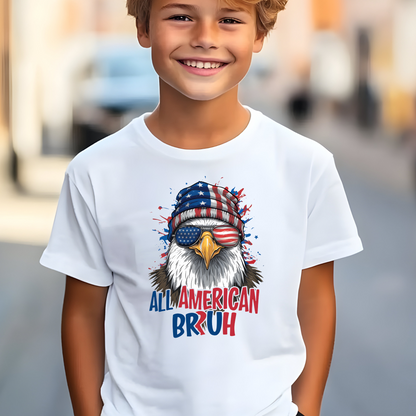 Child wearing a white t-shirt with an eagle graphic and text, standing outdoors.