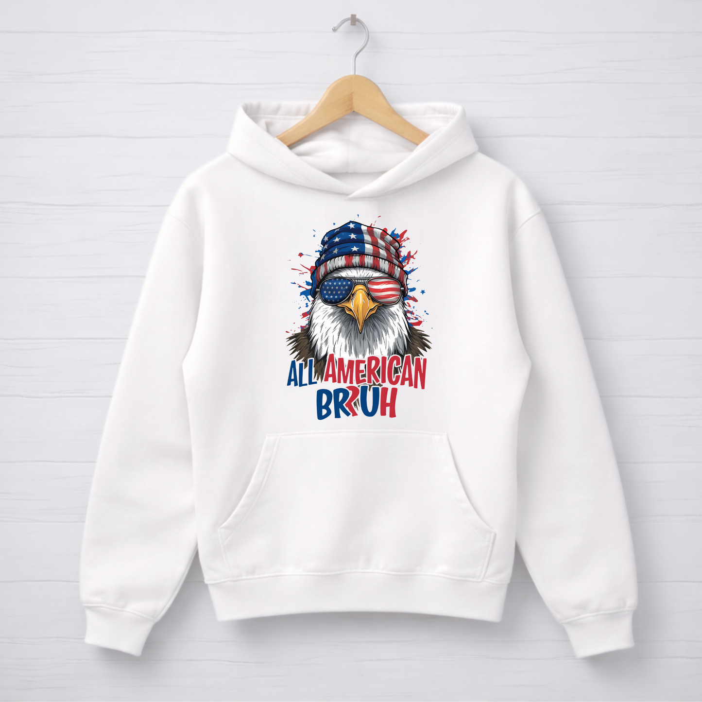 White hoodie with an eagle graphic and text on a white background