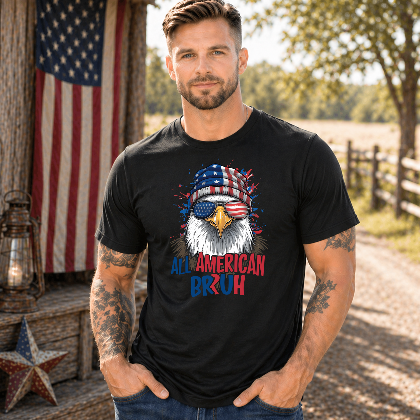 Man wearing a black t-shirt with an eagle graphic and 'All American Bruh' text, standing outdoors with an American flag in the background.