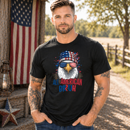 Man wearing a black t-shirt with an eagle graphic and 'All American Bruh' text, standing outdoors with an American flag in the background.