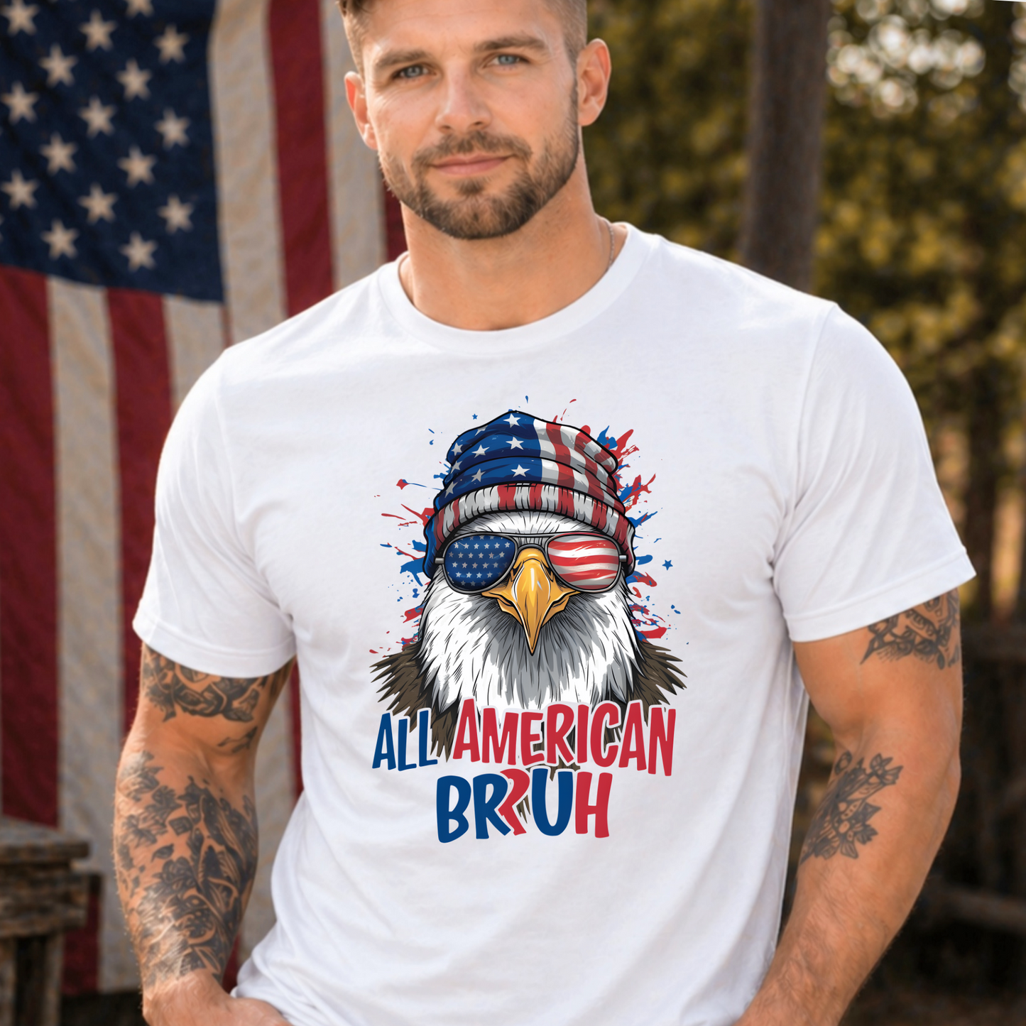Man wearing a white t-shirt with an eagle graphic and 'All American Bruh' text in front of an American flag.