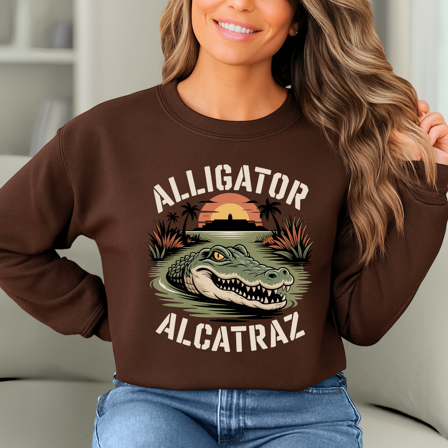 Smiling woman wearing brown Alligator Alcatraz sweatshirt, vintage tropical sunset and alligator design, cozy women’s graphic pullover for casual wear"
