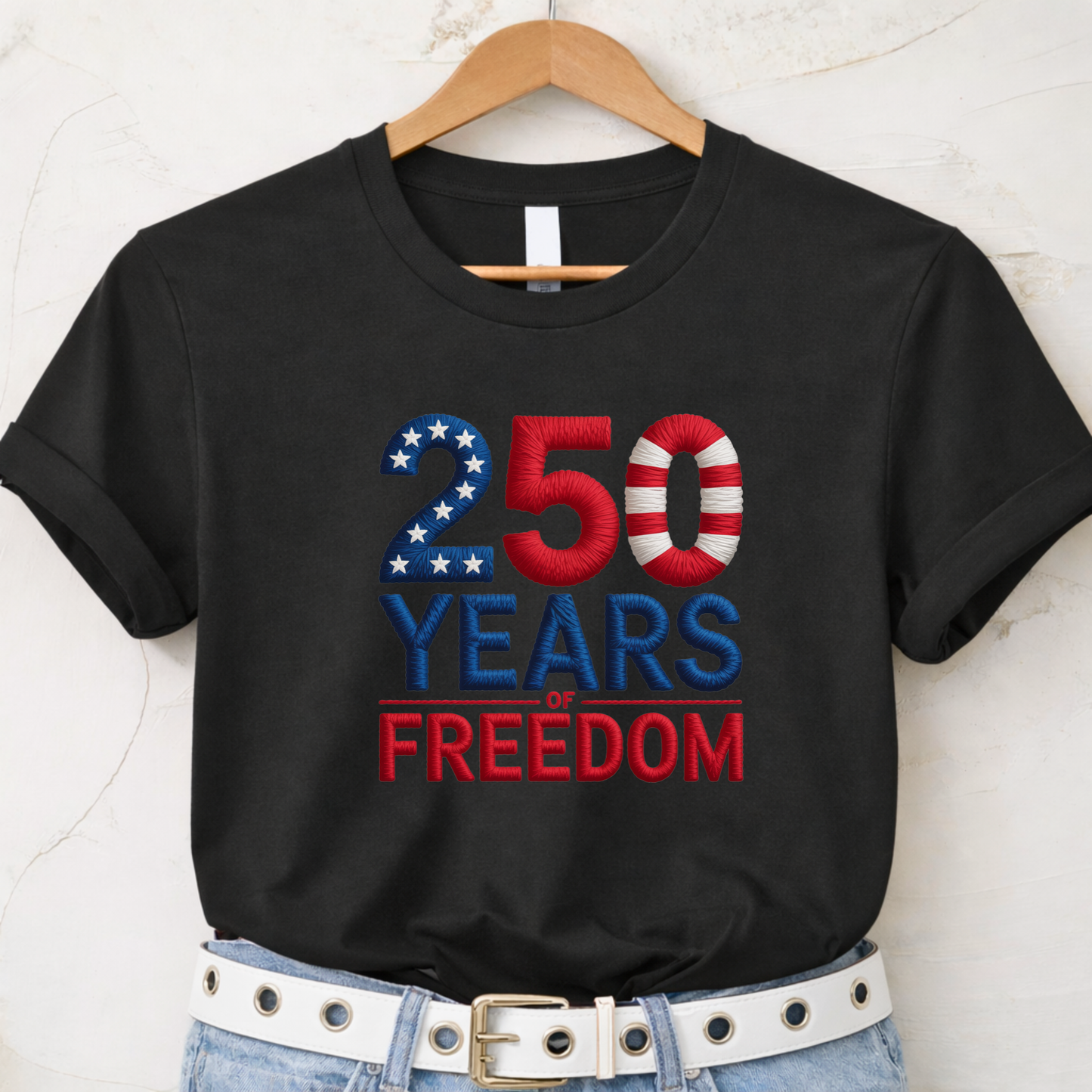 Black T-shirt with 250 Years of Freedom patriotic design hanging on wooden hanger
