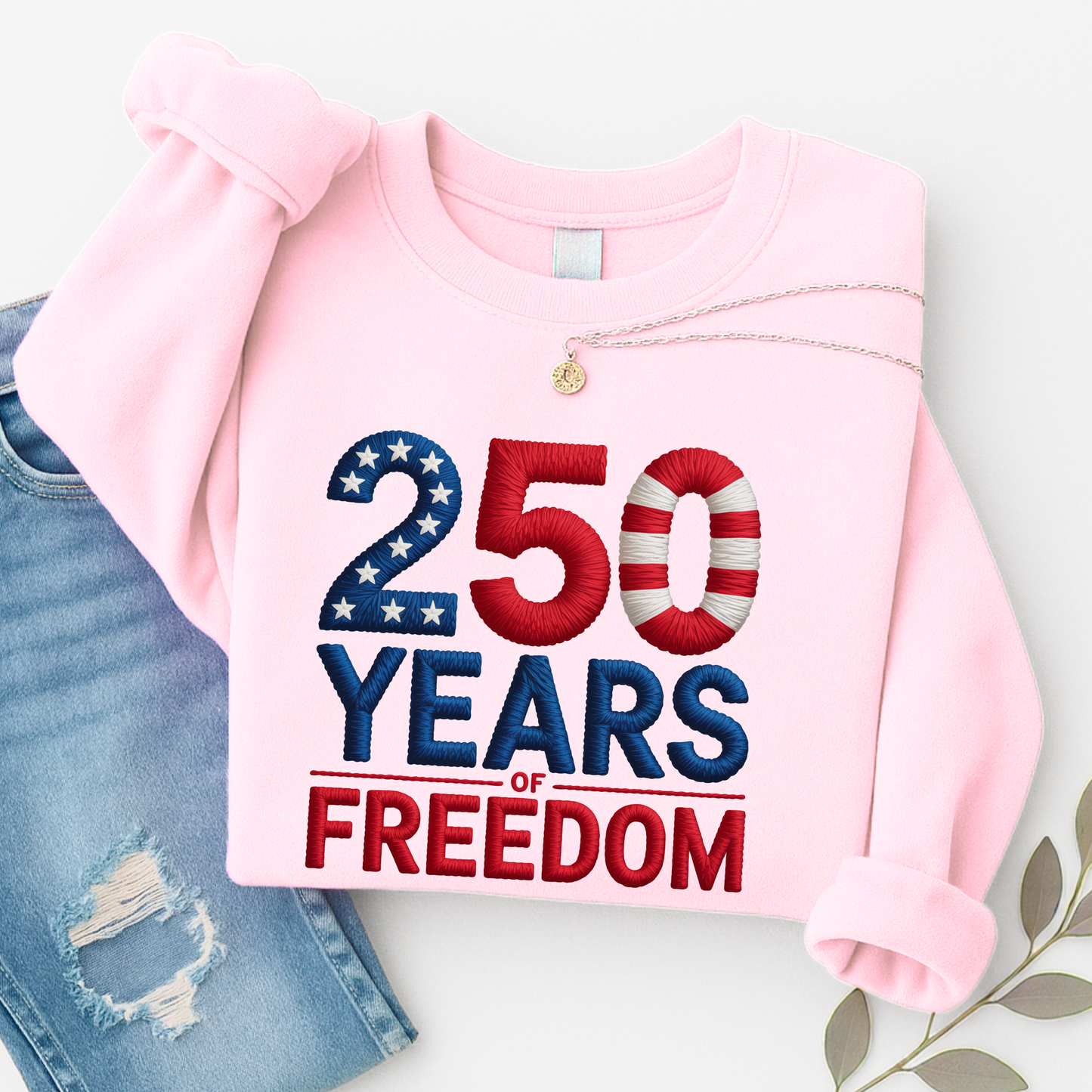 Light pink sweatshirt with 250 Years of Freedom patriotic design folded with sleeves tucked