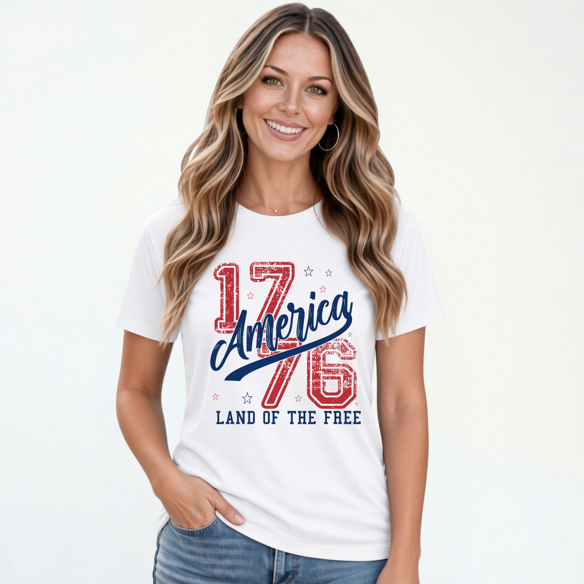 Smiling woman wearing a white T-shirt with a distressed red and blue America 1776 Land of the Free graphic