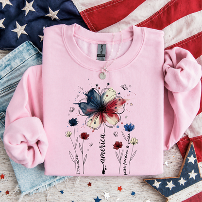 Light pink America 250 floral patriotic sweatshirt with watercolor flower graphic and Faith Family Freedom design