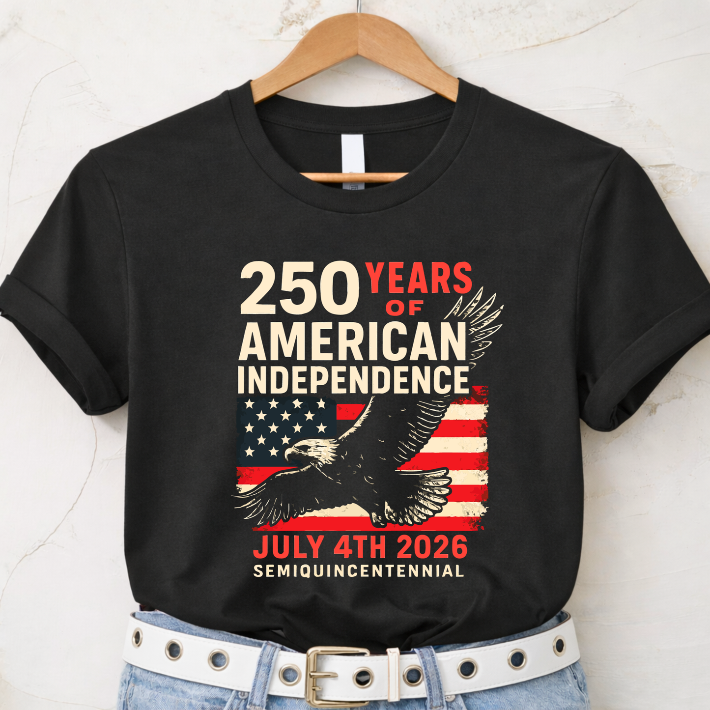Black t-shirt with American Independence Day design featuring an eagle and flag, hanging on a wooden hanger.
