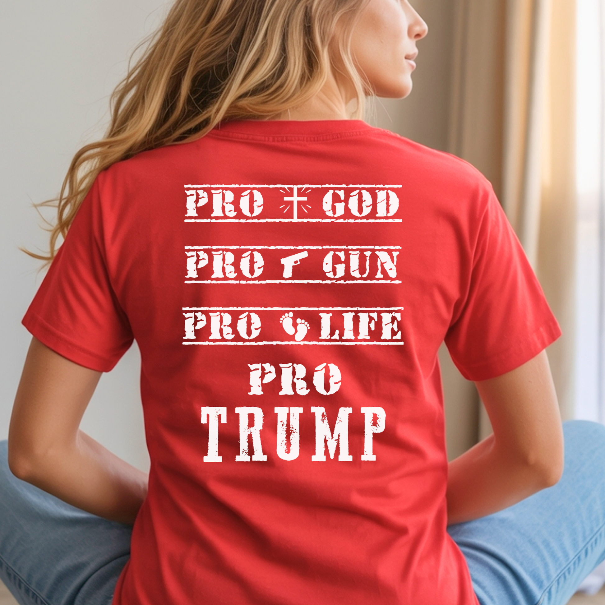 Person wearing a red t-shirt with 'PRO GOD', 'PRO GUN', 'PRO LIFE', 'PRO TRUMP' text on the back.
