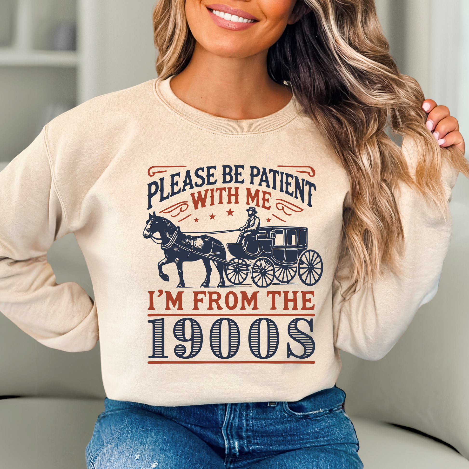 Woman in sand color sweatshirt with Please Be Patient With Me I’m From the 1900s text and horse carriage print – retro nostalgic unisex crewneck gift