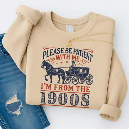 Folded sand sweatshirt with necklace and jeans styled flat lay – Please Be Patient With Me I’m From the 1900s funny vintage crewneck gift idea