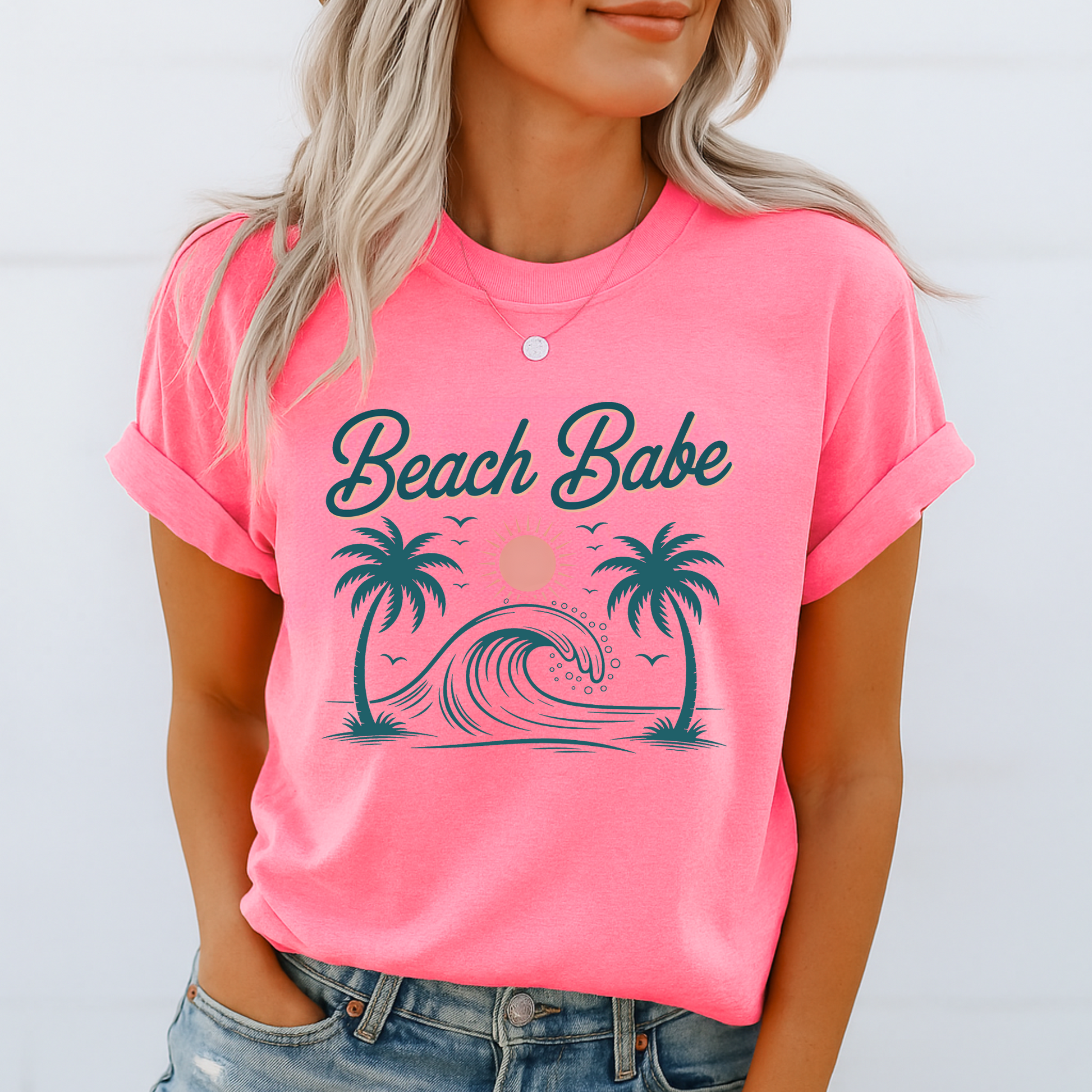 Bright pink Beach Babe shirt with rolled sleeves and denim shorts, vibrant beach-themed design