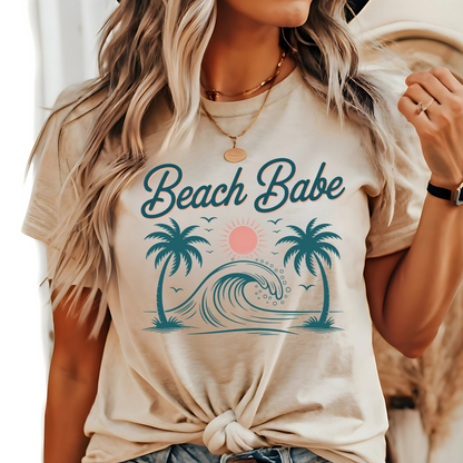 Sand-colored T-shirt with tied front, woman in casual summer outfit with Beach Babe print