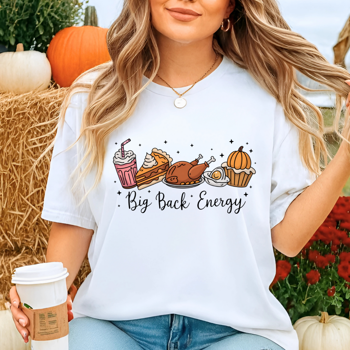 White T-shirt with Big Back Energy design worn at pumpkin patch with coffee cup