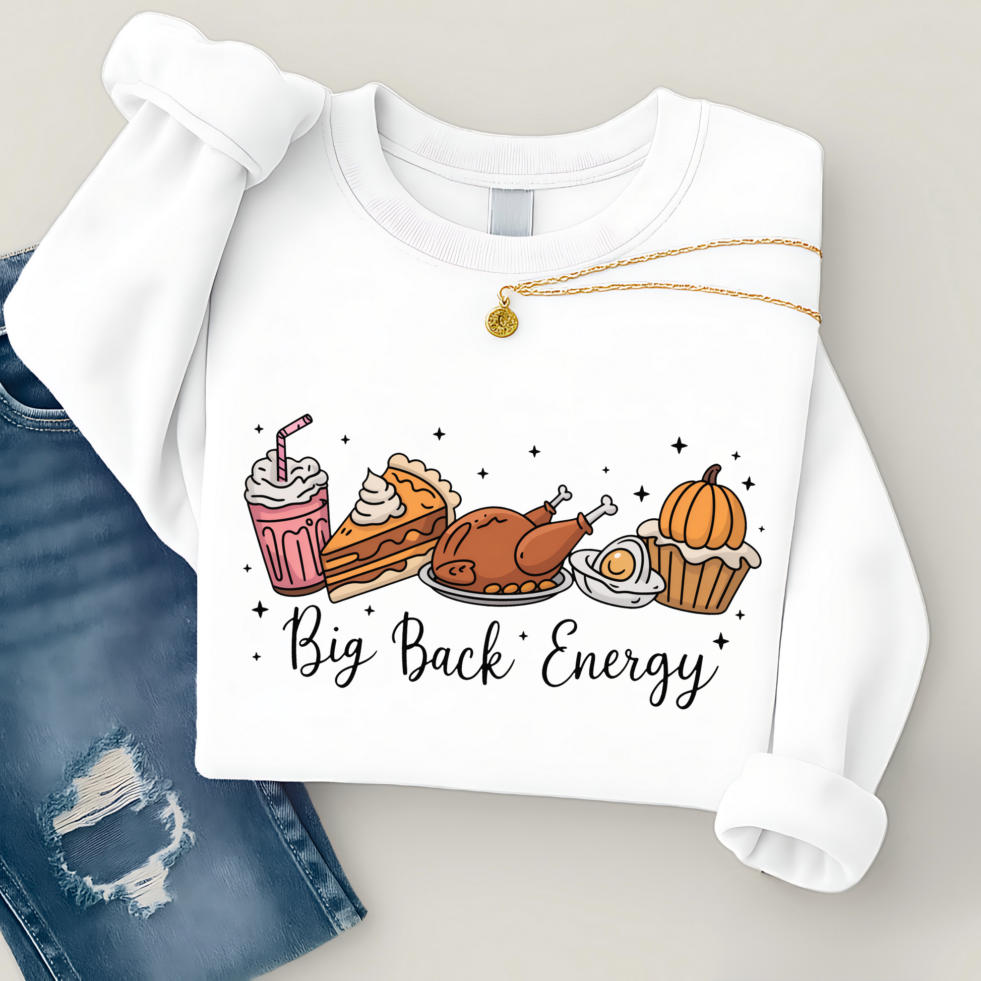 White sweatshirt with food illustrations and 'Big Back Energy' text, paired with blue jeans.