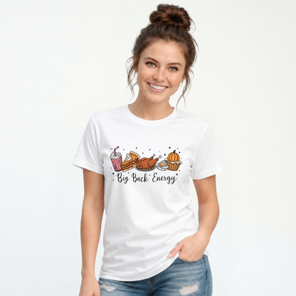 White T-shirt featuring cartoon Thanksgiving foods and Big Back Energy wording, worn by a smiling woman with her hair in a bun.
