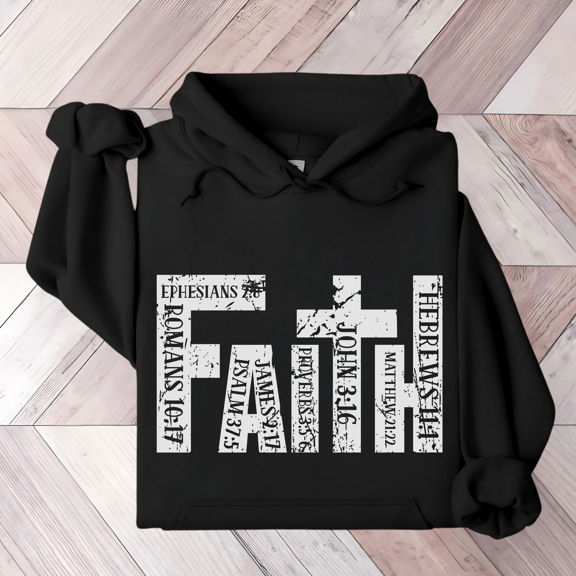 Black FATH Hooded Christian hoodie on table