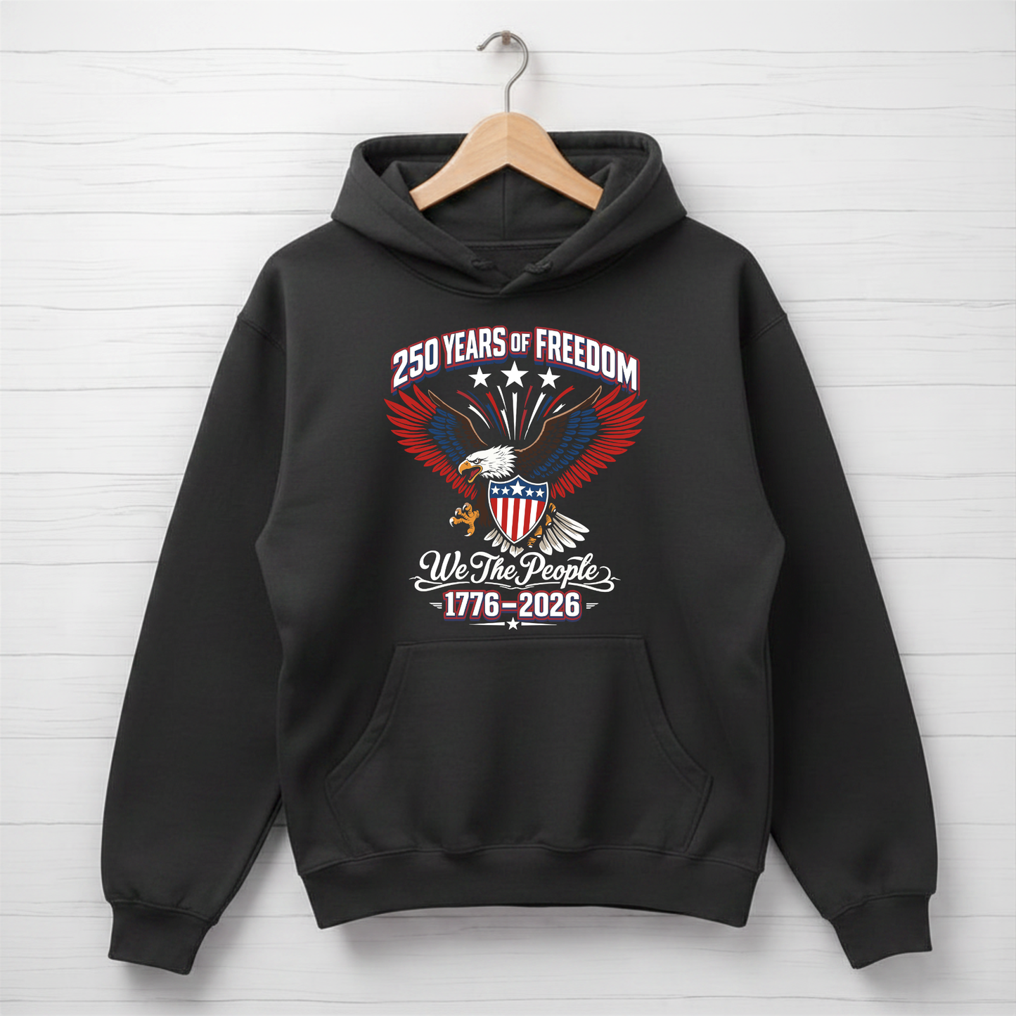 Black America 250 hoodie with an eagle and text design on a white wooden background