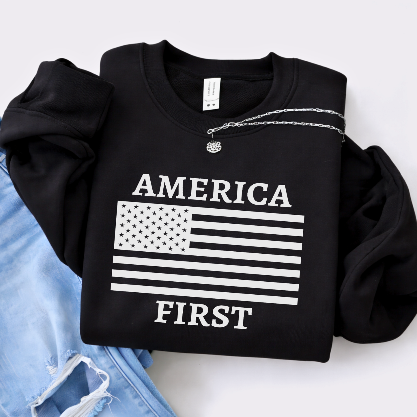 Black America First patriotic women’s unisex sweatshirt with white American flag graphic