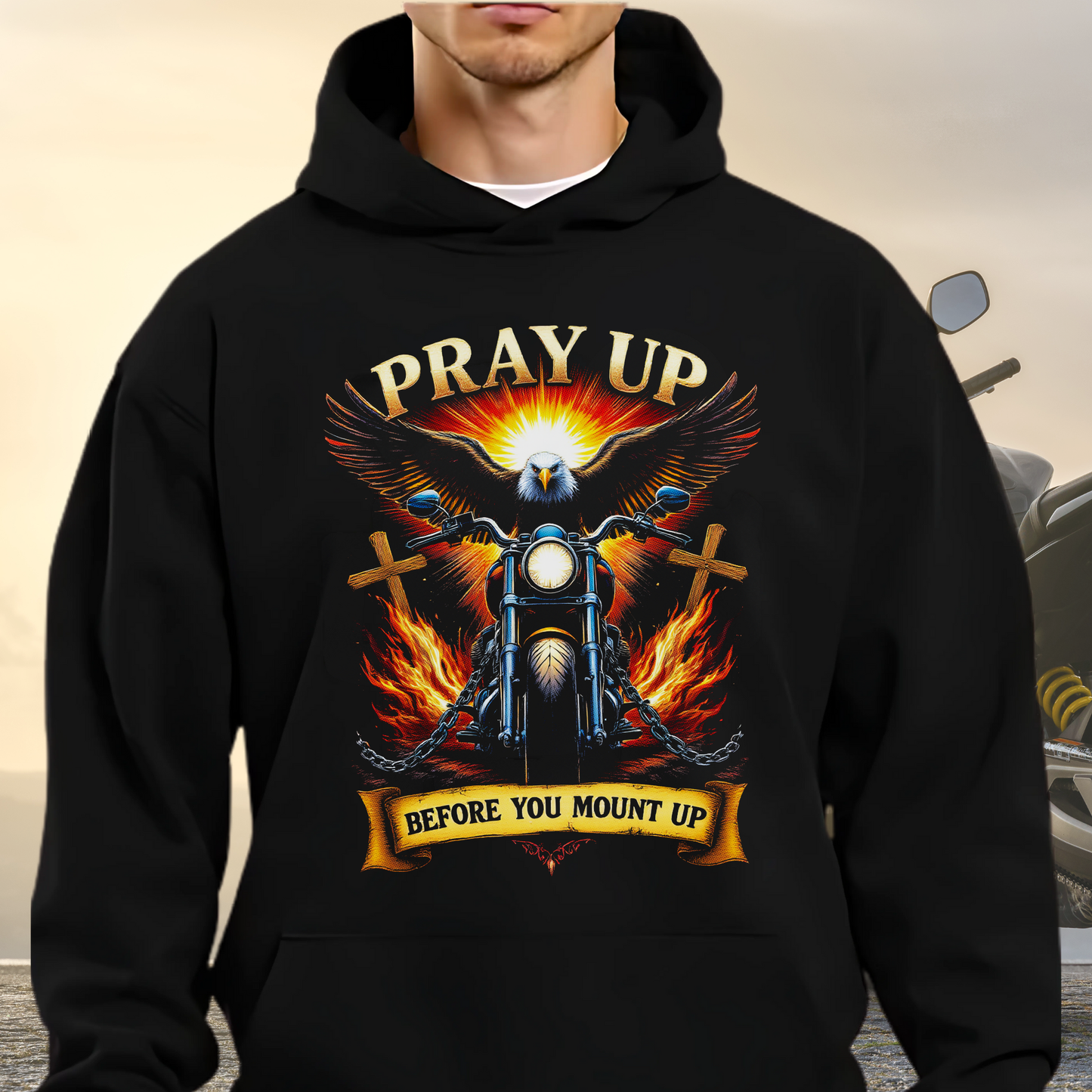 Black hoodie with a graphic design of an eagle, motorcycle, and text 'Pray Up Before You Mount Up' on a neutral background.