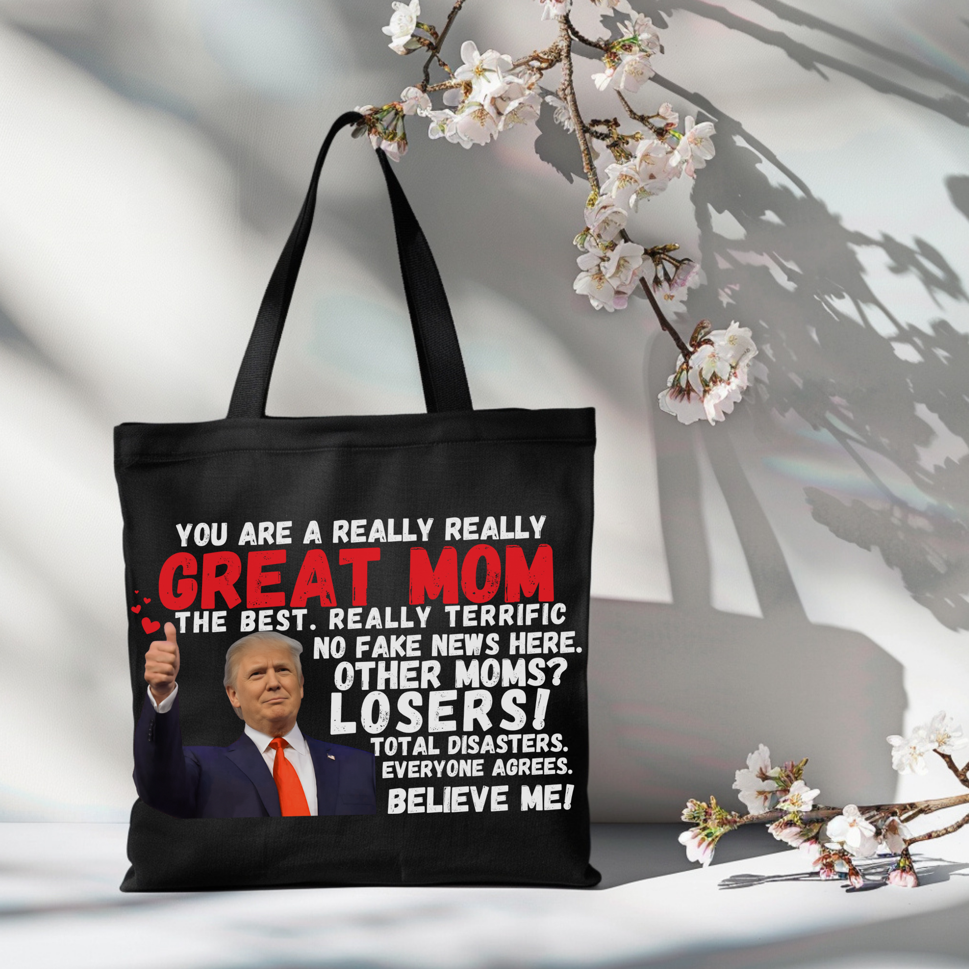 Black tote bag with Trump quote hanging on chair – patriotic gift for her