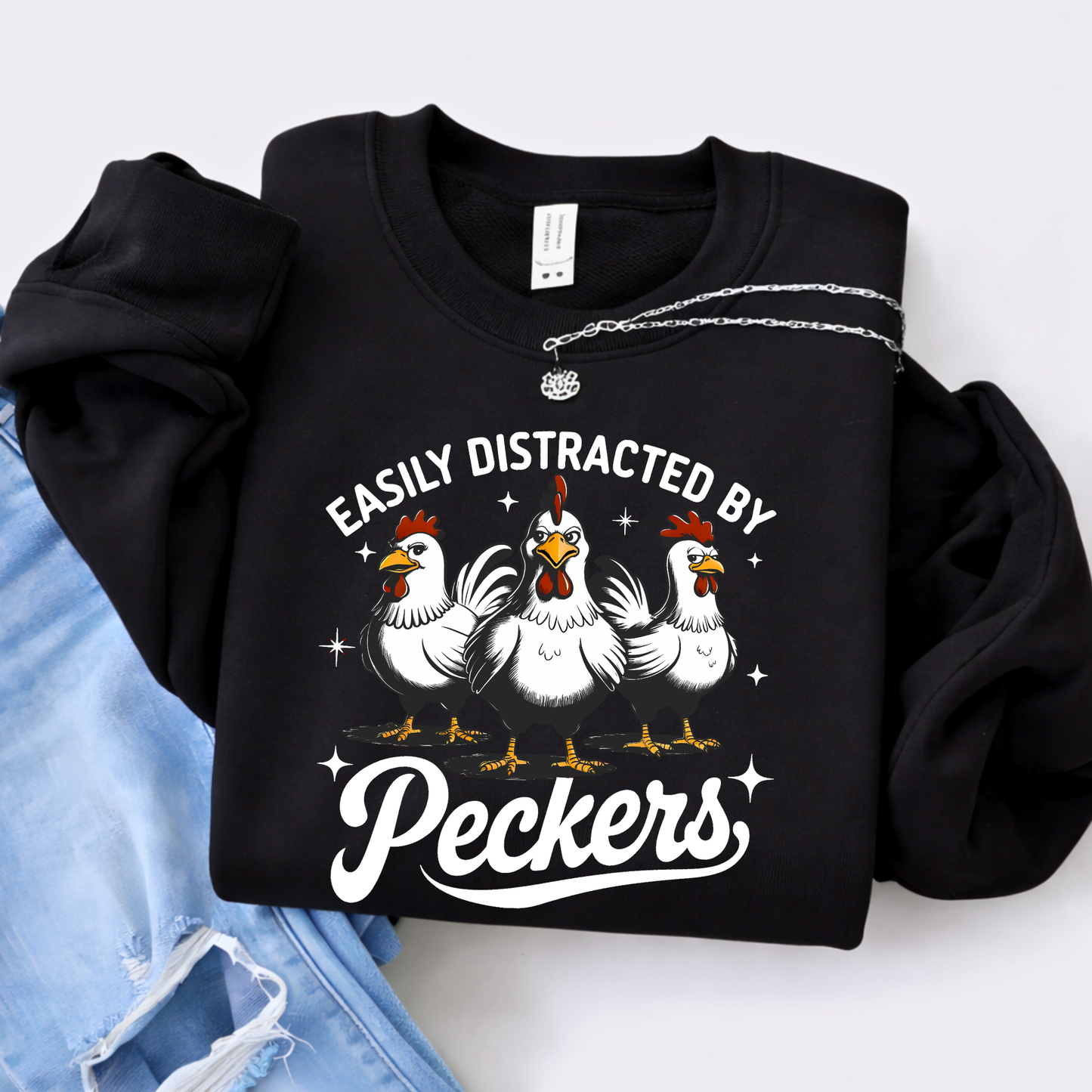 Black sweatshirt with chicken graphic and text 'Easily Distracted by Peckers' on a white background.