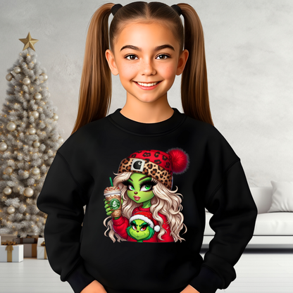 Youth black Christmas sweatshirt featuring the Boujee Green Girl festive graphic. Cozy kids holiday pullover worn by a smiling girl with pigtails.