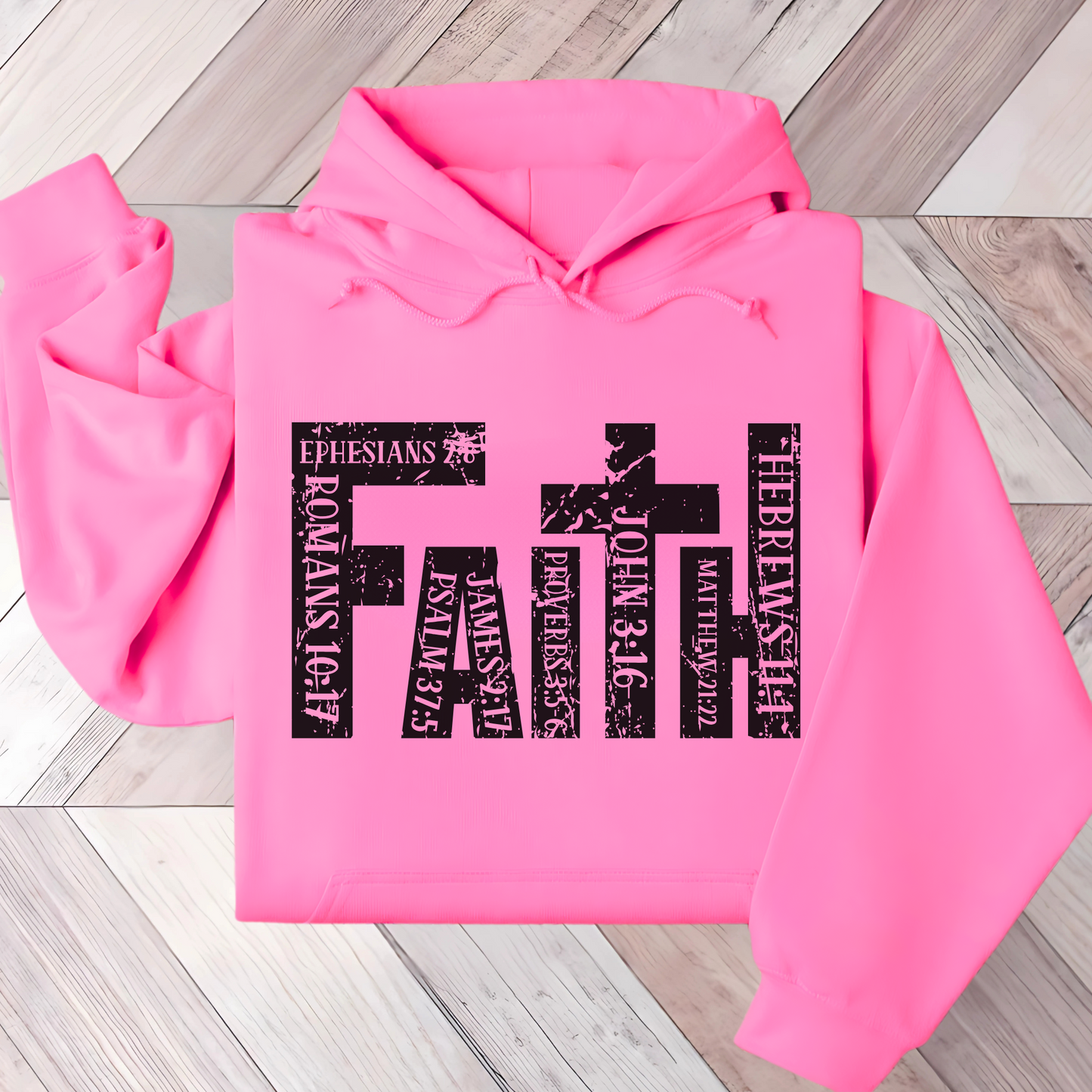 Bright Pink Christian hoodie featuring 'FAITH' in bold distressed white letters, designed with Bible verse references including John 3:16, Romans 10:17, Hebrews 11:1, and more. Inspirational religious sweatshirt for faith-based fashion.