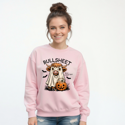 Woman wearing a Light Pink crewneck sweatshirt with the Bullsheet Halloween Highland cow ghost and jack-o'-lantern design.