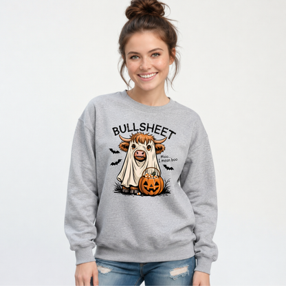 Woman wearing a Sports Gray crewneck sweatshirt with the Bullsheet Halloween Highland cow ghost and jack-o'-lantern design.