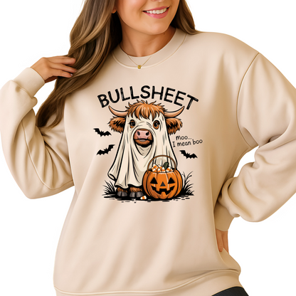 Beige sweatshirt with a cow in a ghost costume and pumpkin graphic, worn by a person.