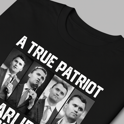 Black t-shirt with Charlie Kirk, 'A True Patriot' text and images of a man holding a microphone on a gray background