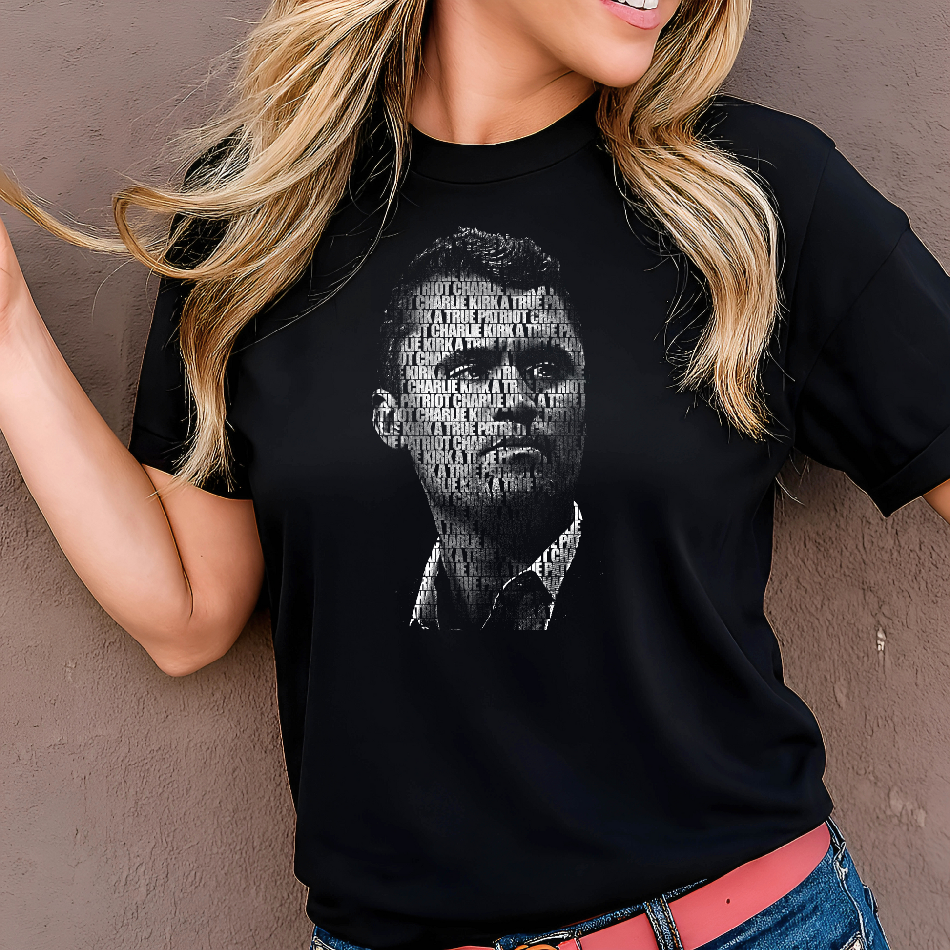 Person wearing a black t-shirt with a graphic design against a plain background