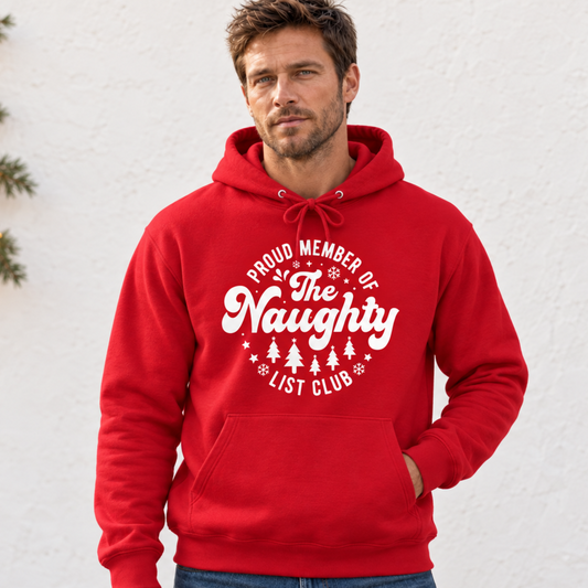 Man wearing a red hoodie with a white Proud Member of the Naughty List Club Christmas design against a simple light background.