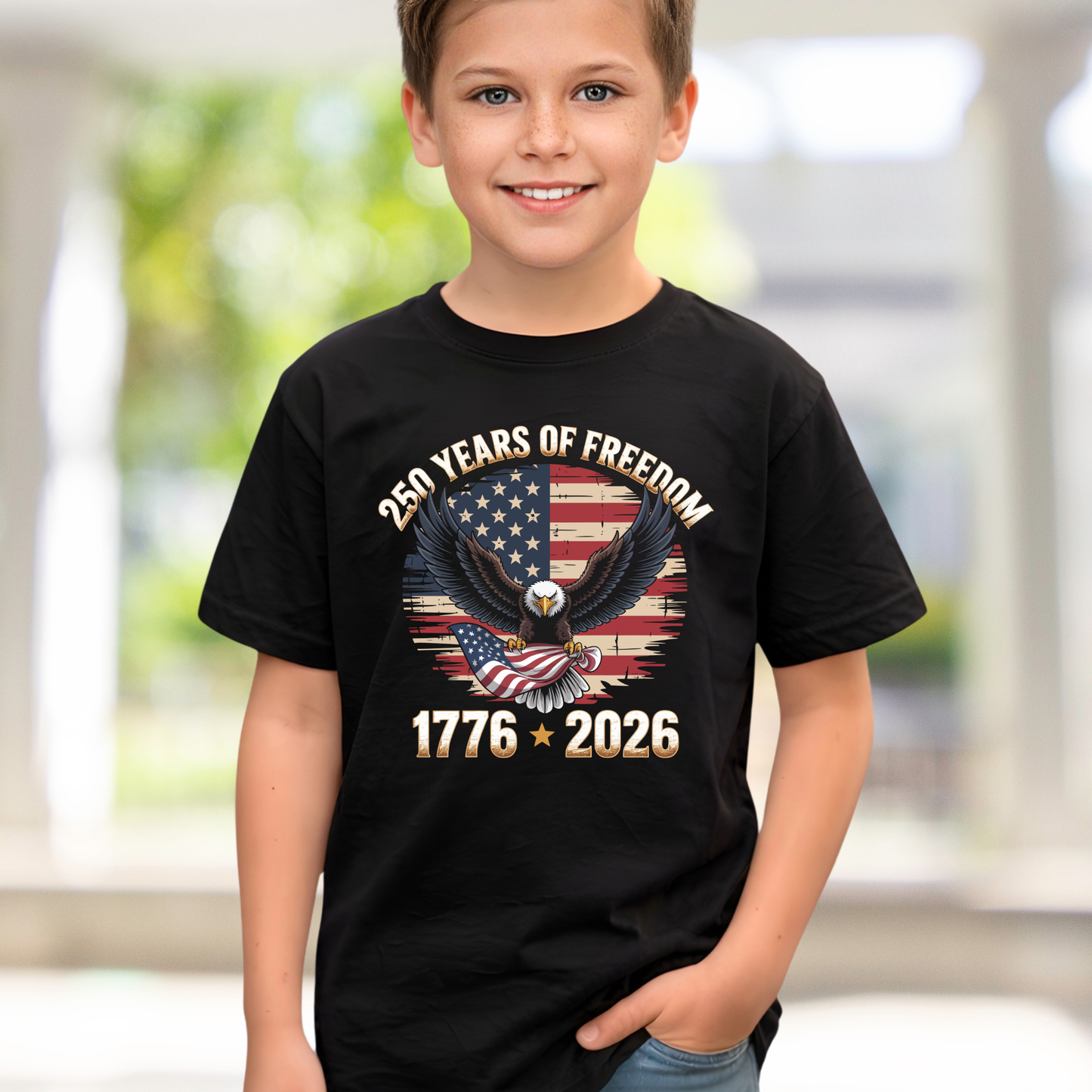 Child wearing a black t-shirt with an eagle and American flag design, celebrating 250 years of freedom.