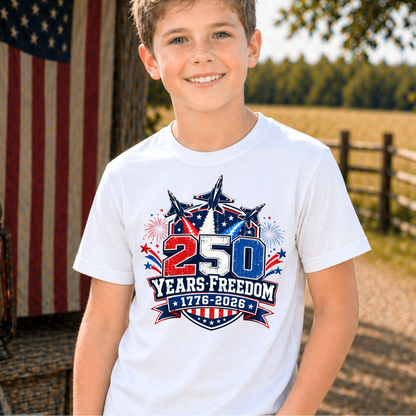 Child wearing a white t-shirt with a 250 Years Freedom design, standing outdoors with an American flag in the background.