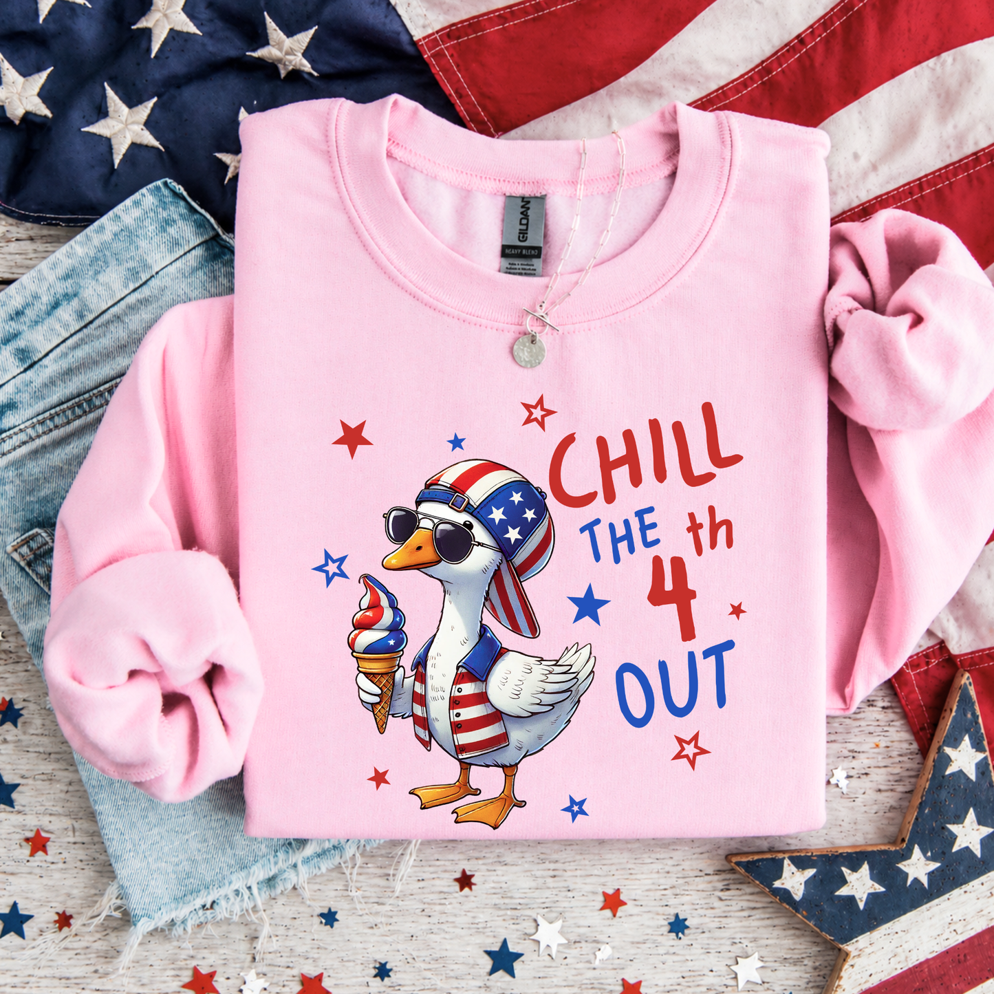 Pink sweatshirt with a goose graphic and 'Chill the 4th Out' text on an American flag background