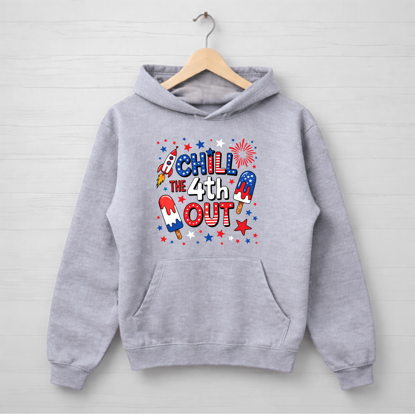Gray hoodie with 4th of July-themed design on a wooden hanger against a light gray background