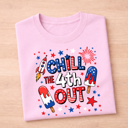 Pink t-shirt with 4th of July-themed design on a wooden surface