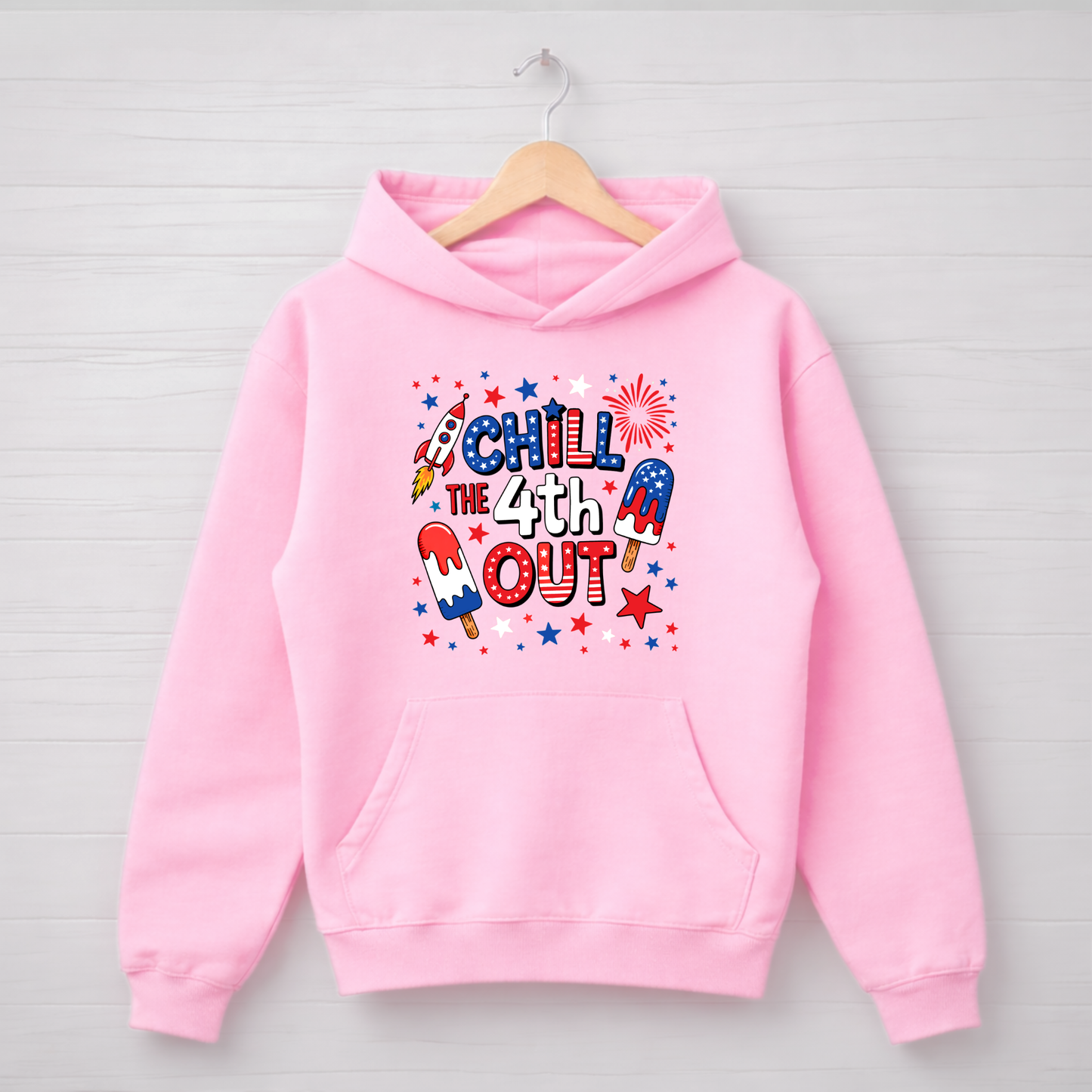 Pink hoodie with 'Chill the 4th Out' text and graphics on a wooden hanger against a light gray background