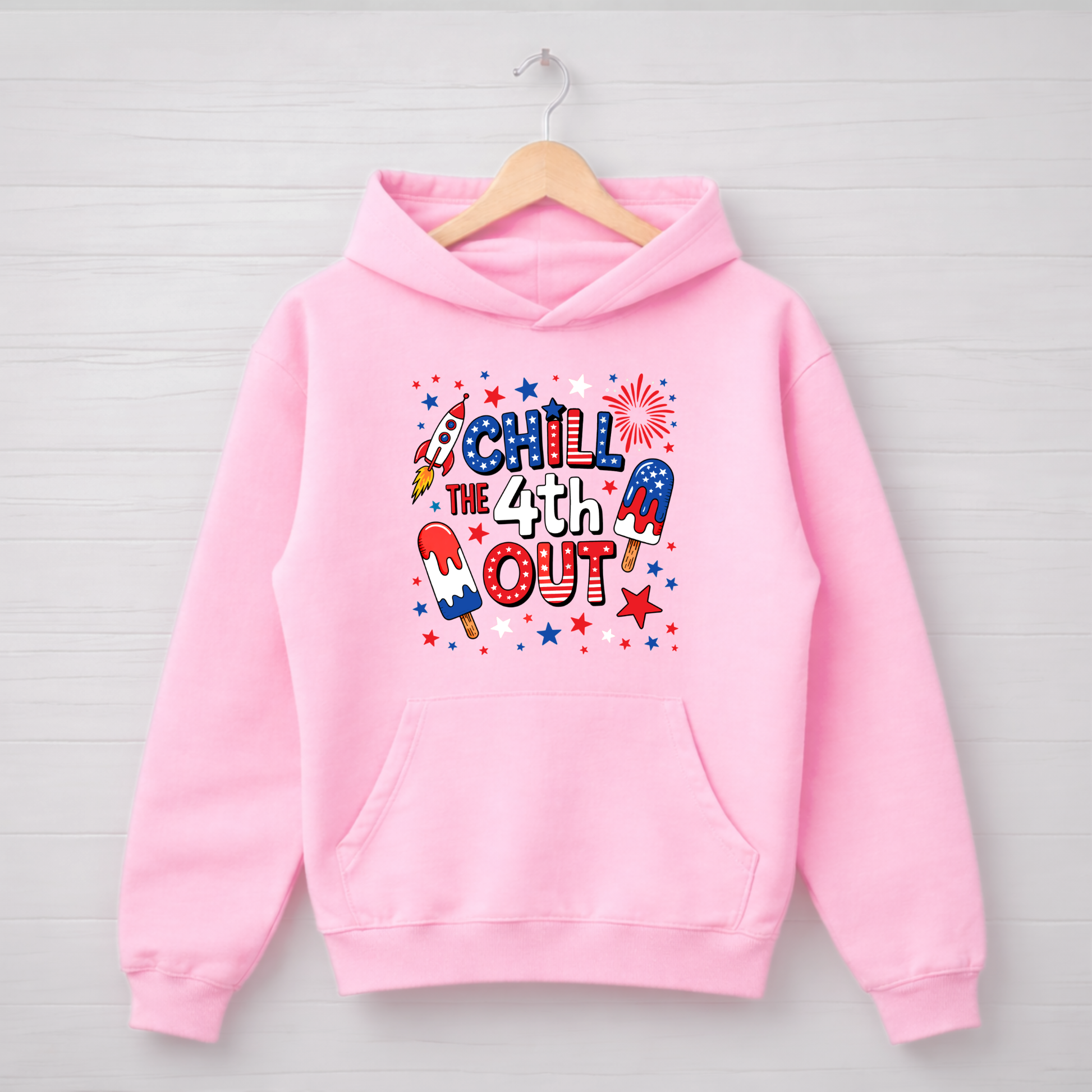 Pink hoodie with 'Chill the 4th Out' text and graphics on a wooden hanger against a light gray background