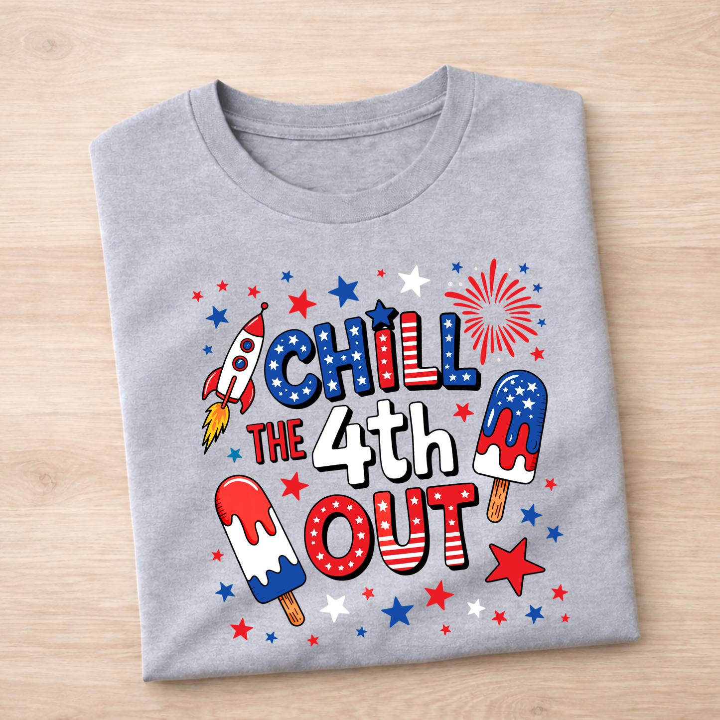 Gray t-shirt with 4th of July-themed design on a wooden surface