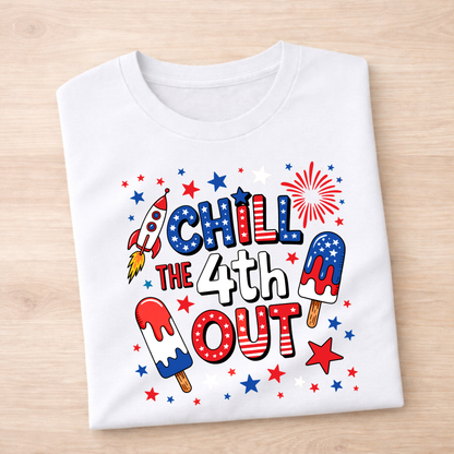 White t-shirt with 4th of July-themed design on a wooden surface