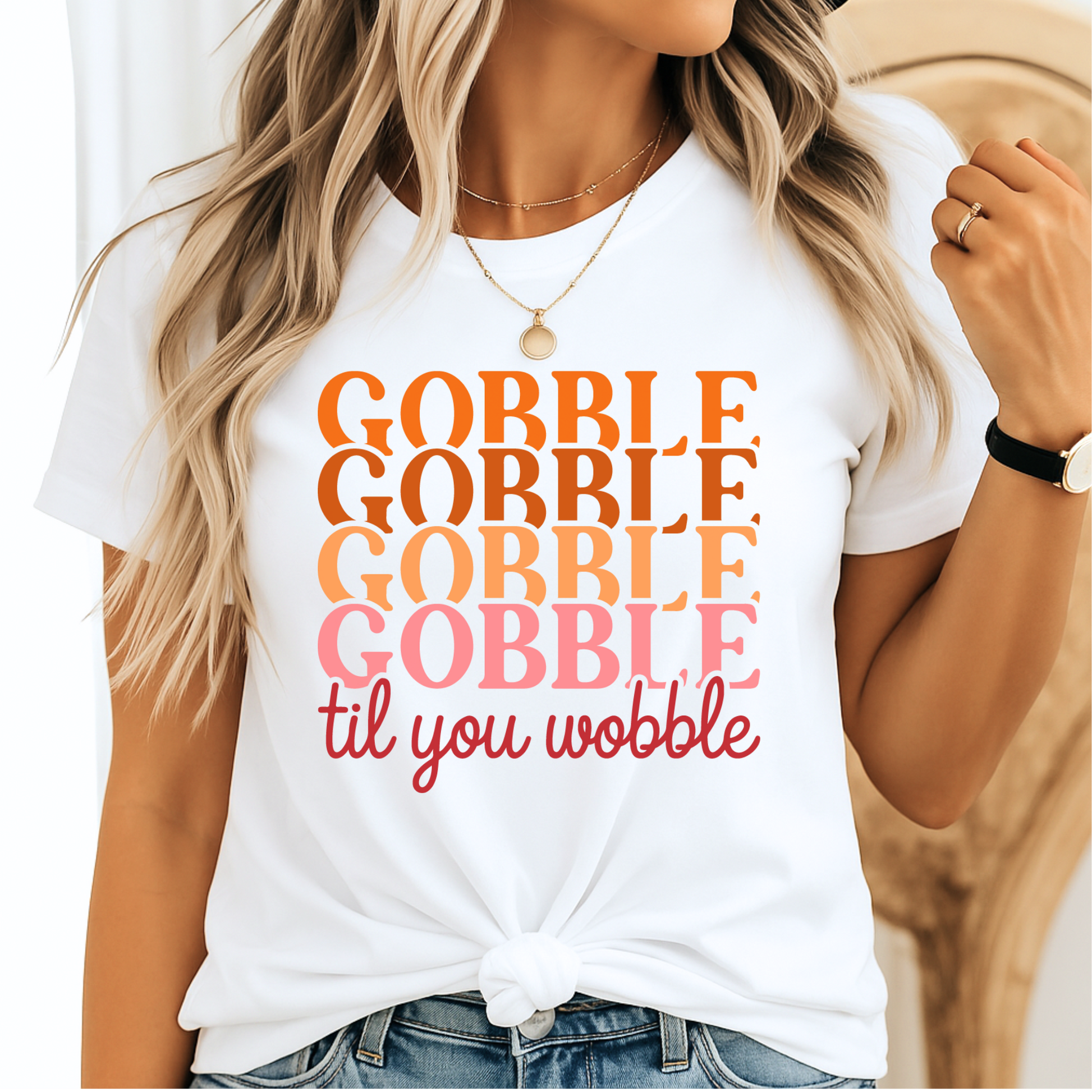 Classic white t-shirt knotted at the waist featuring “Gobble Til You Wobble” in a bright retro fall palette – casual Thanksgiving fashion