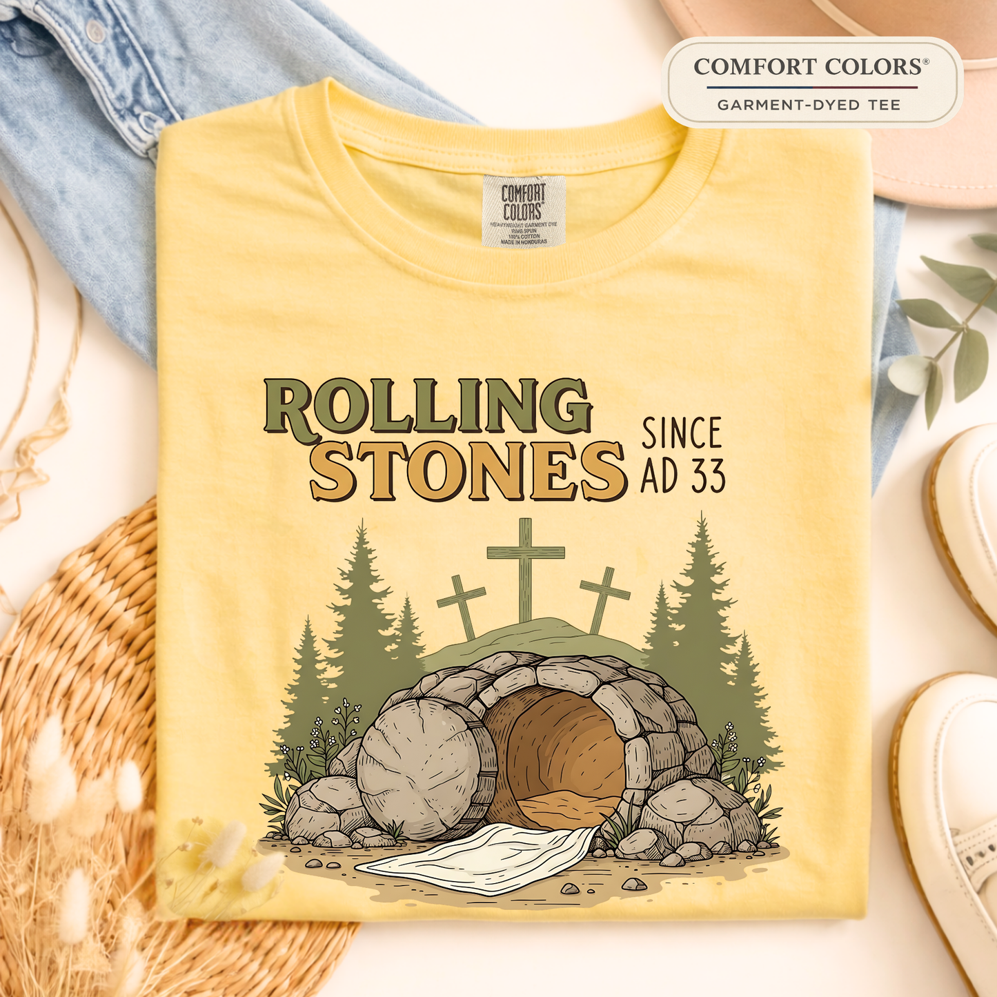 Comfort Colors butter yellow Christian graphic t-shirt folded with empty tomb design and rustic neutral background