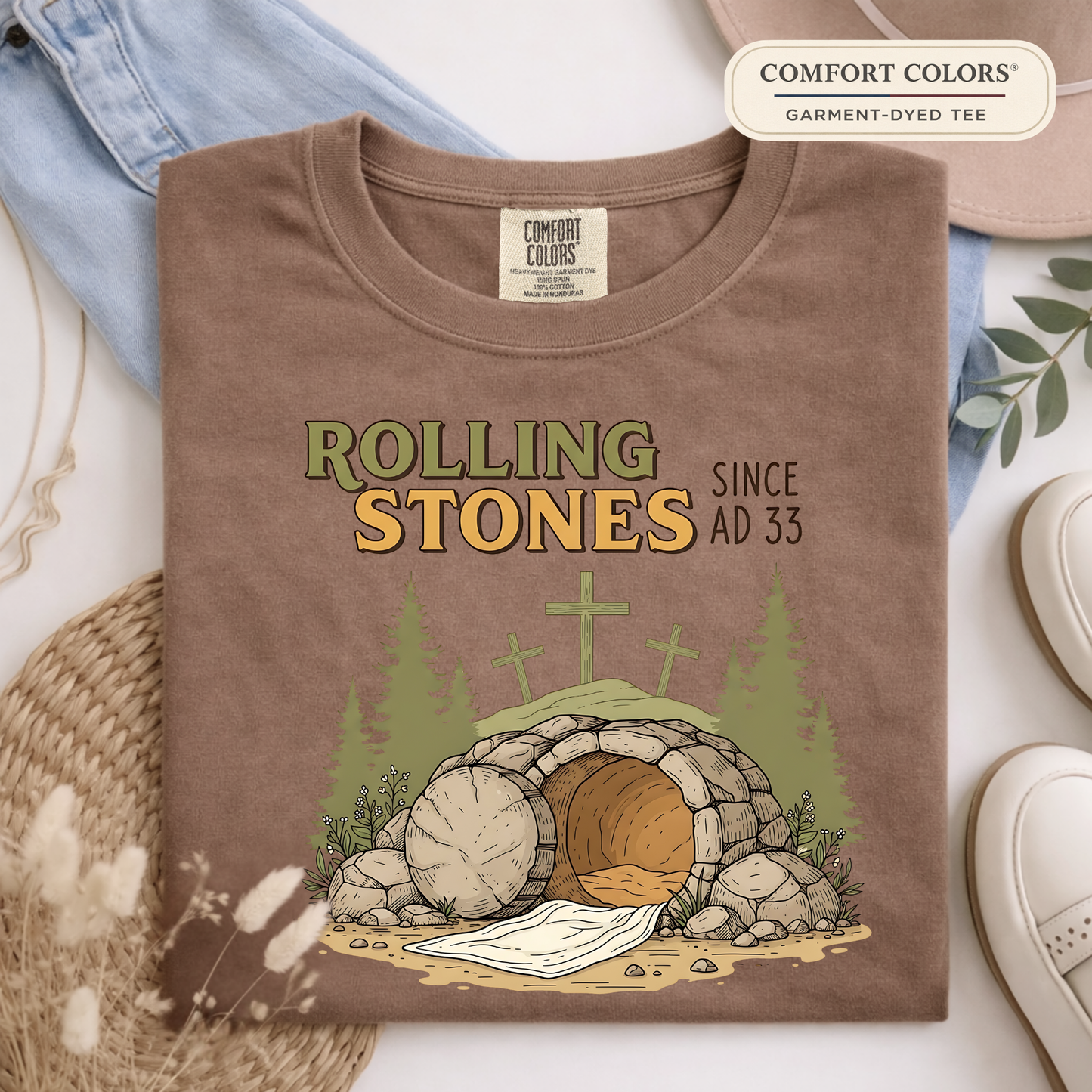 Comfort Colors espresso brown Christian t-shirt with Rolling Stones AD 33 design folded flat lay with neutral accessories