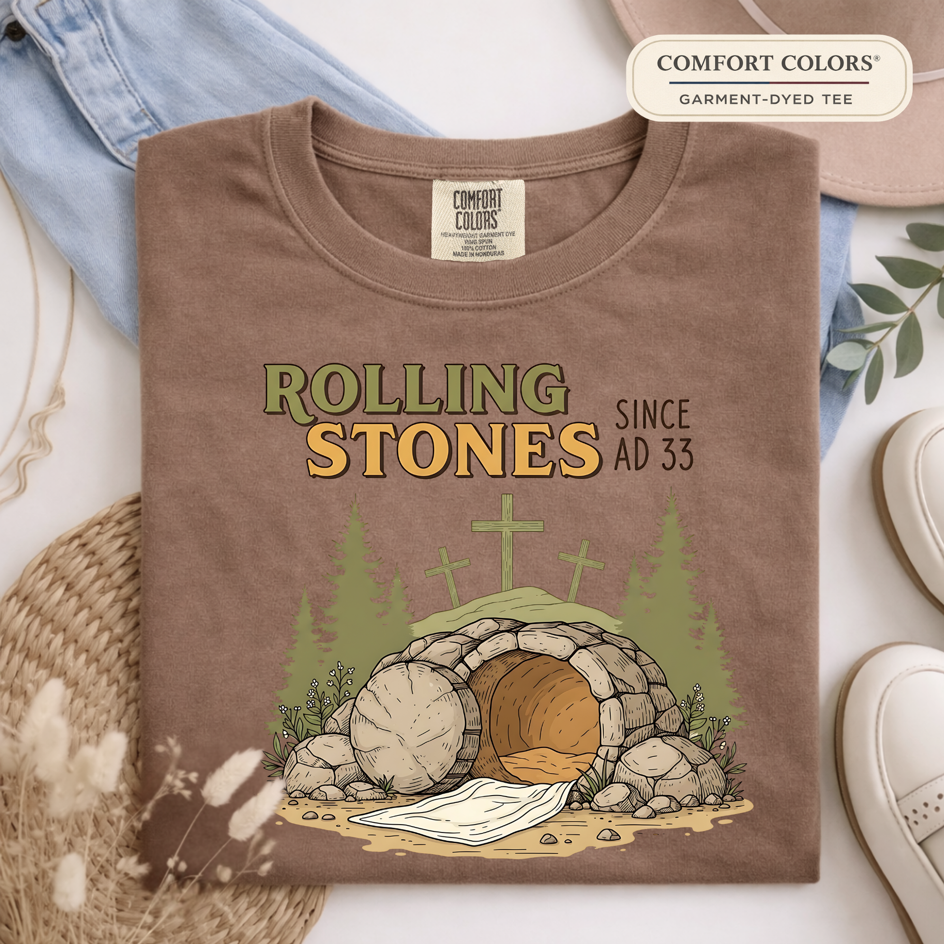 Comfort Colors espresso brown Christian t-shirt with Rolling Stones AD 33 design folded flat lay with neutral accessories